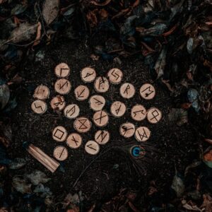 runic letters on wood chunks and ground with autumn leaves